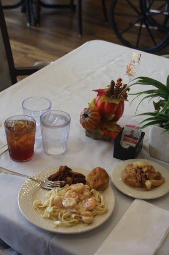 A cozy dining table showcasing a delicious meal and refreshing drinks.