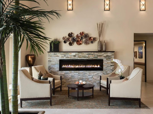 A cozy and modern living room featuring a stylish fireplace, comfortable seating, and elegant decor elements.