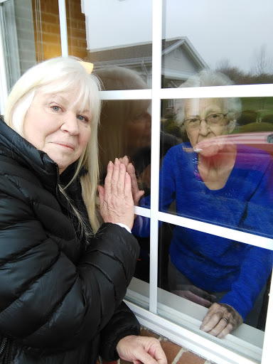 A touching moment of connection through a window, symbolizing love and family ties.
