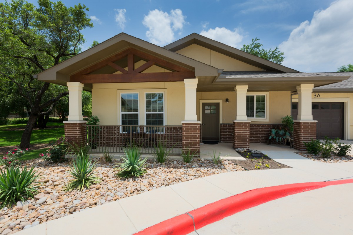 A suburban house with a landscaped front yard and a driveway.