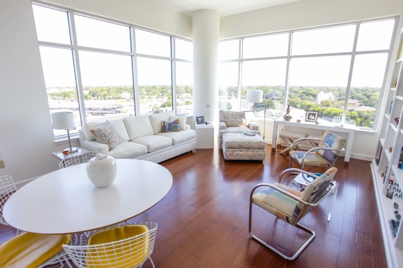 A modern, bright living room with large windows and stylish furniture.