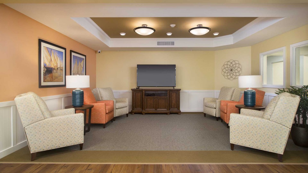A cozy living room with comfortable seating and a large television.