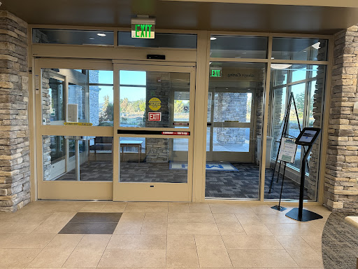 A view of the entrance area featuring automatic glass doors and an inviting lobby space.