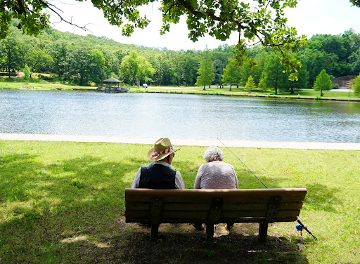 Two individuals enjoying a peaceful moment by the lake.