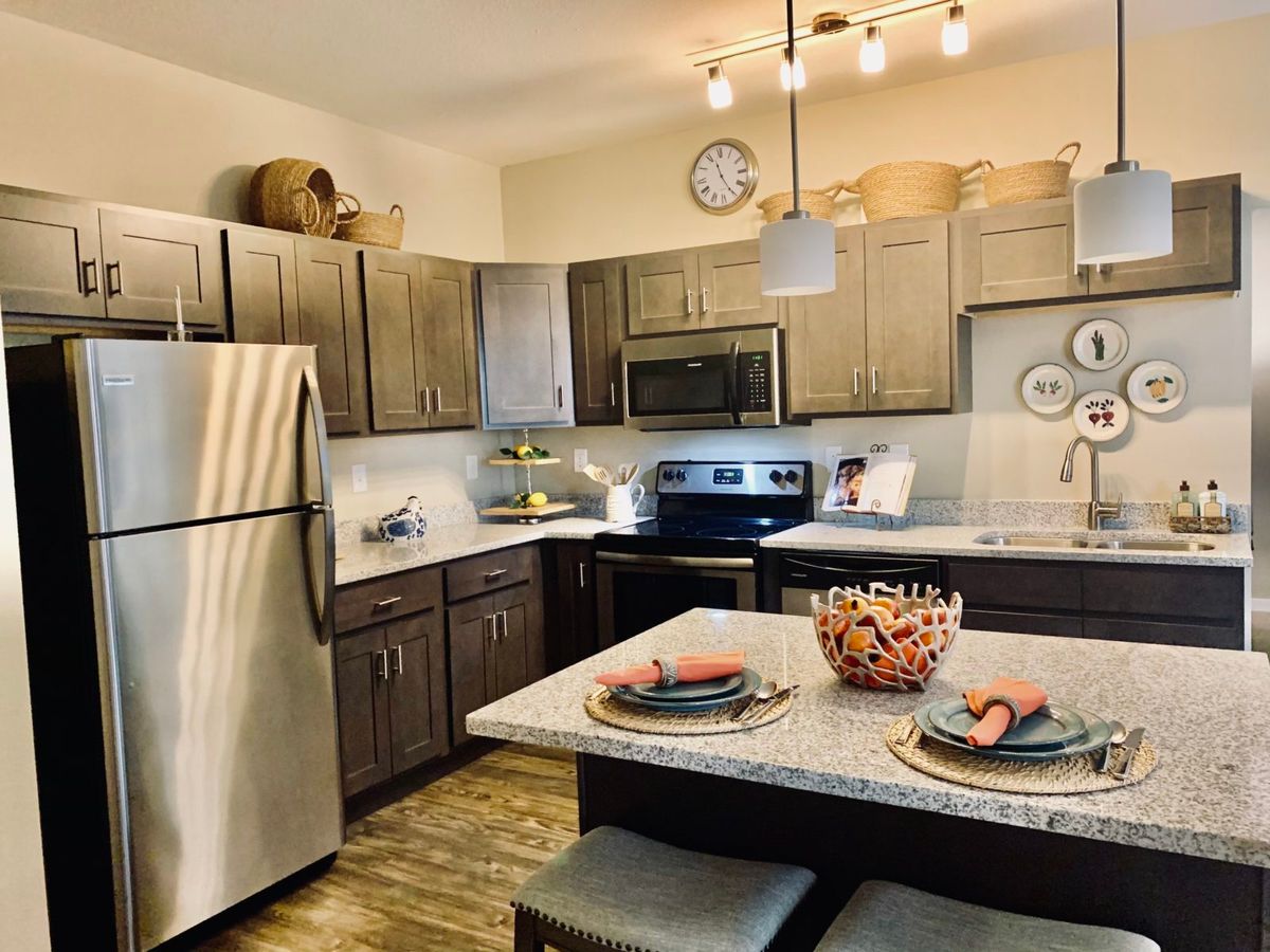 Modern kitchen with stainless steel appliances and a cozy dining setup.