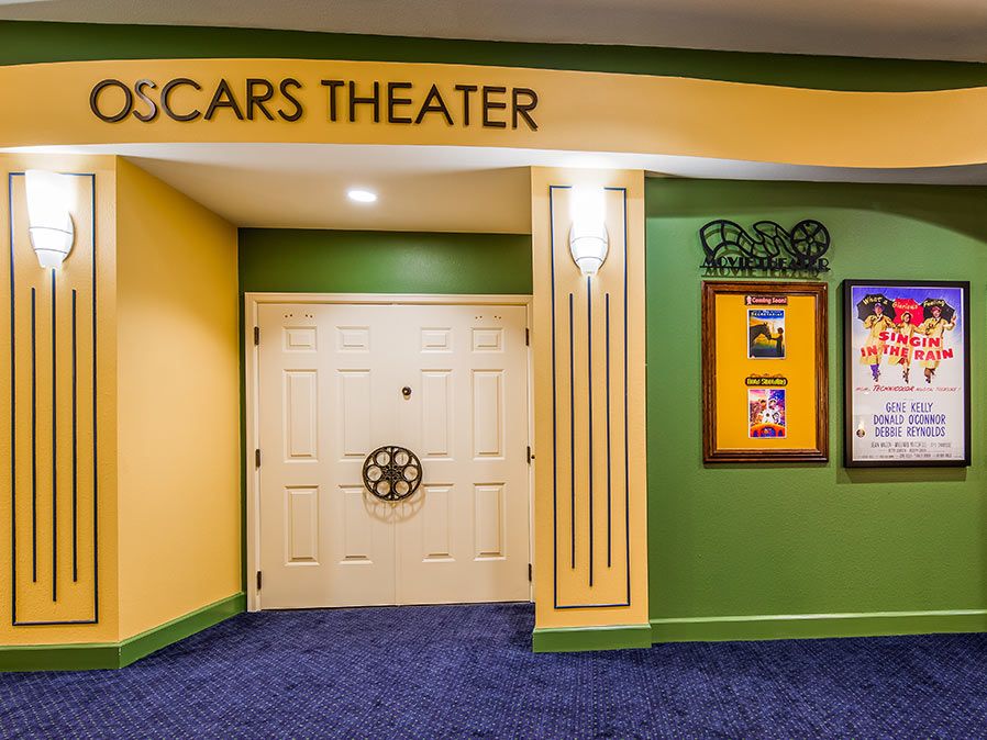 Entrance to a theater with colorful walls and movie posters.