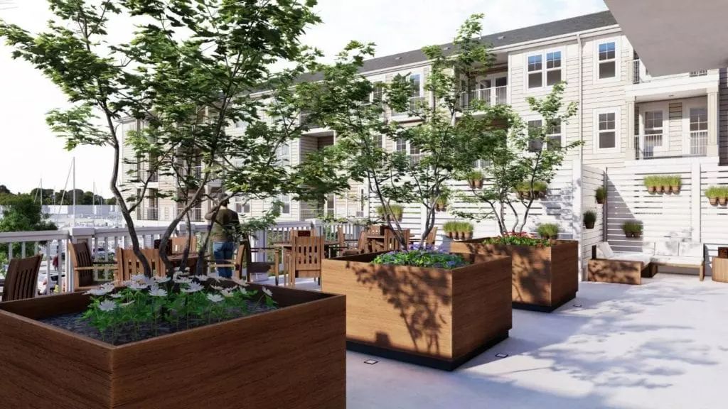 A rooftop garden with large wooden planters and trees creating a serene outdoor space.