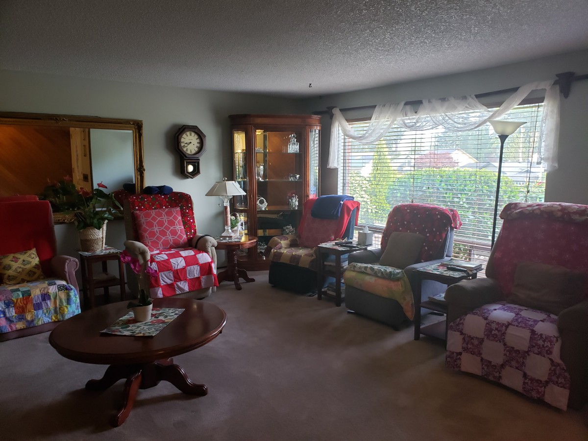 A cozy living room with multiple chairs and a coffee table, decorated with various items.