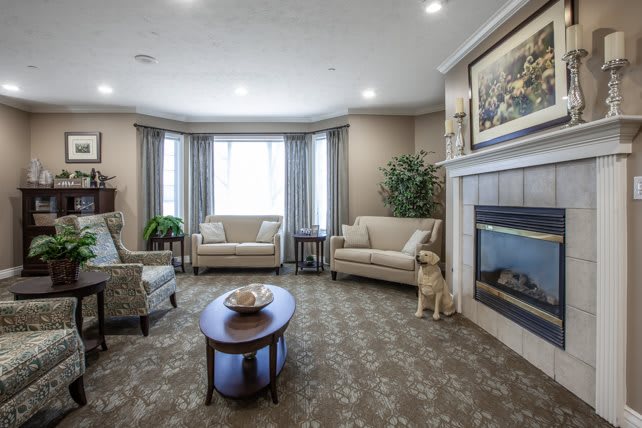A cozy living room with elegant furniture, a warm fireplace, and tasteful decor.