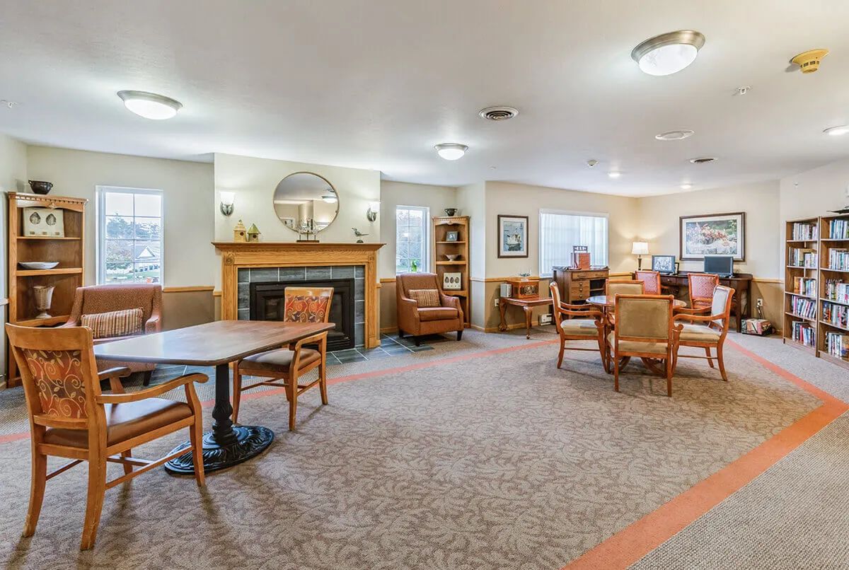 A cozy living room interior with comfortable seating and a fireplace.