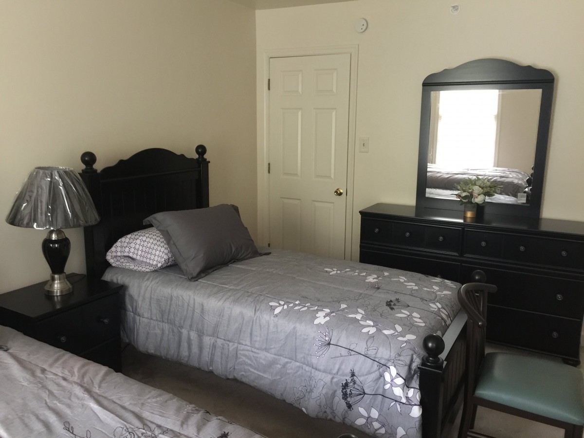 A cozy bedroom with twin beds and classic furniture.