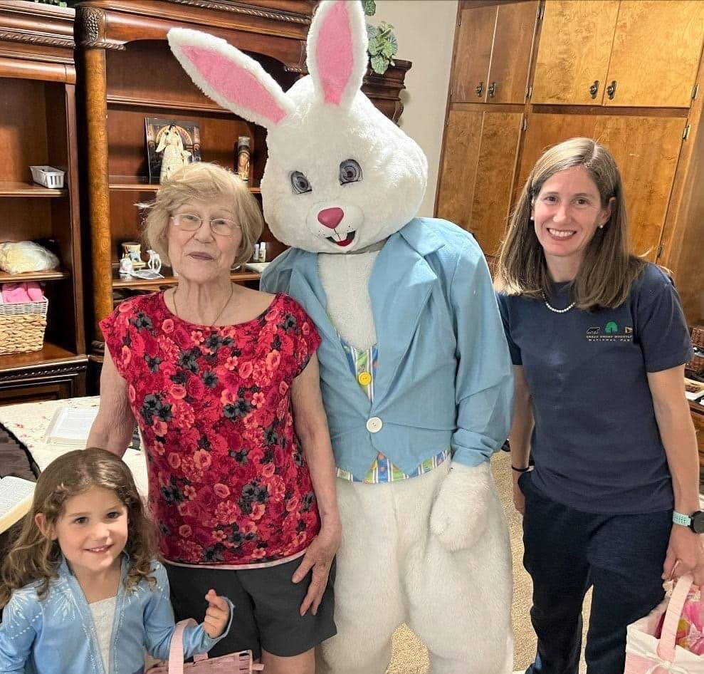 A family posing with a person in an Easter Bunny costume.