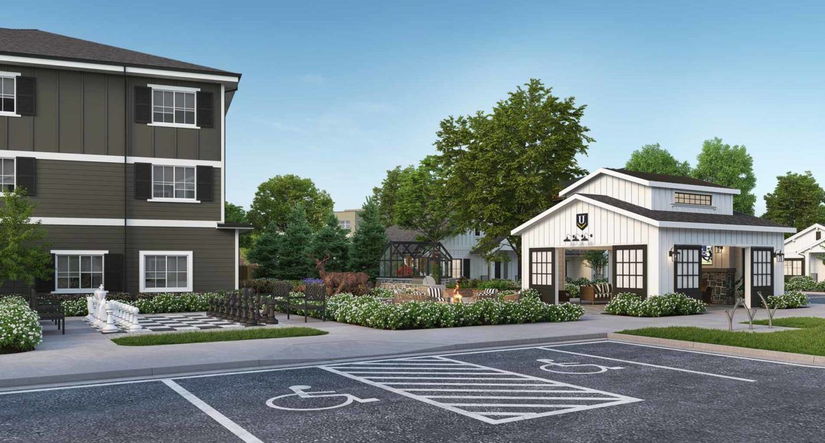 A modern building with a landscaped area and accessible parking spaces.