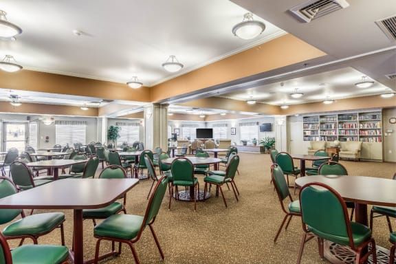 A spacious dining area with multiple tables and chairs set up for guests.