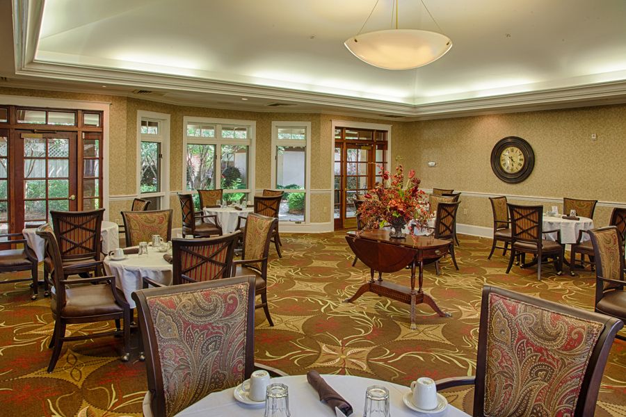 An elegantly decorated dining room with neatly arranged tables and chairs.