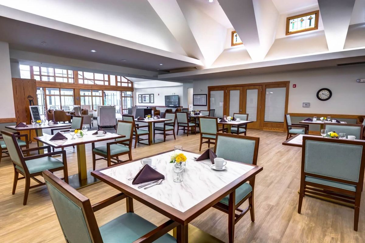 A modern dining room with neatly arranged tables and chairs, showcasing elegant interior design.