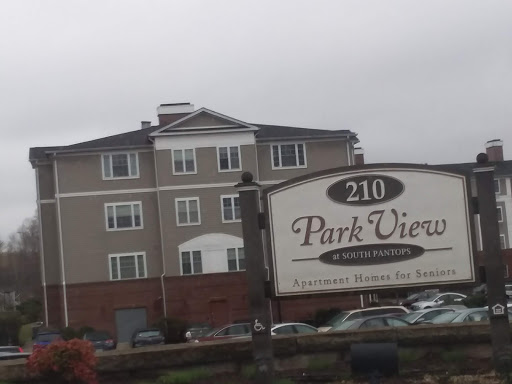 Park View Apartments, a residential building with signage in an urban setting.