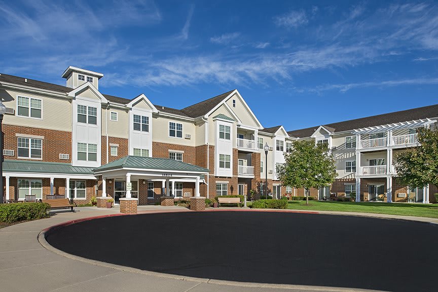 A modern residential apartment complex with a landscaped courtyard.