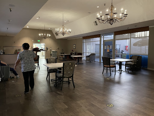 A spacious dining area featuring elegant chandeliers and a cozy atmosphere.