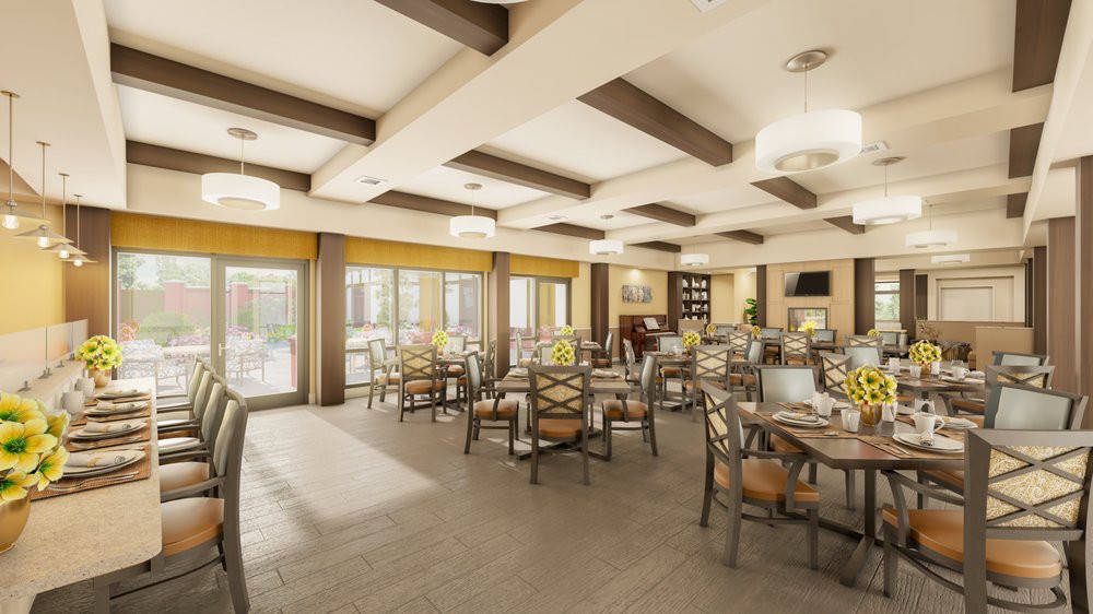 A well-lit dining room with neatly arranged tables and chairs, featuring wooden beams and large windows.