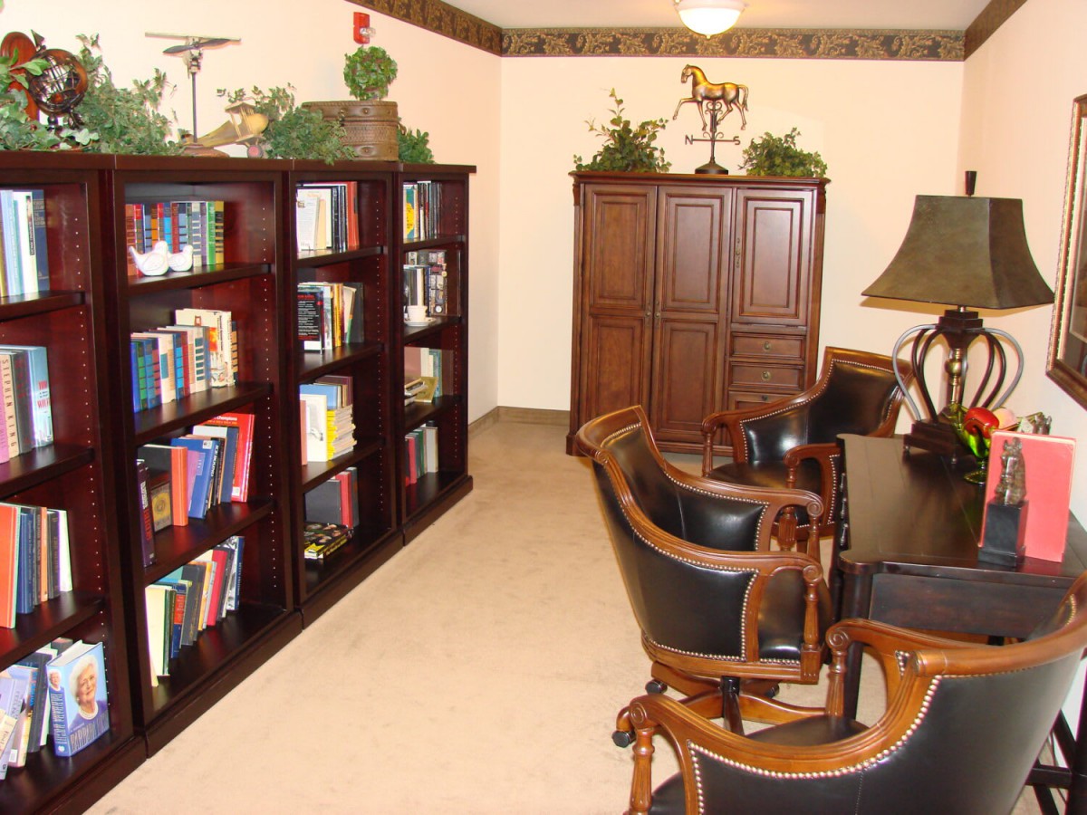 A cozy reading room with bookshelves and elegant furniture.