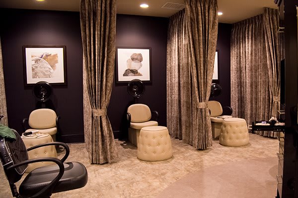 Elegant salon interior with plush seating and decorative curtains.