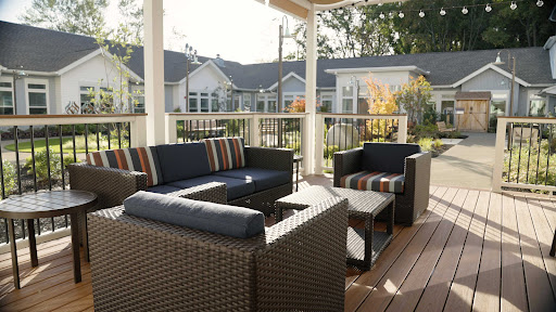 A cozy outdoor seating area featuring stylish furniture, perfect for enjoying the sun.