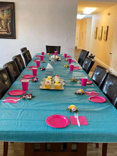 A beautifully arranged table for a festive gathering, featuring vibrant teal and pink colors.