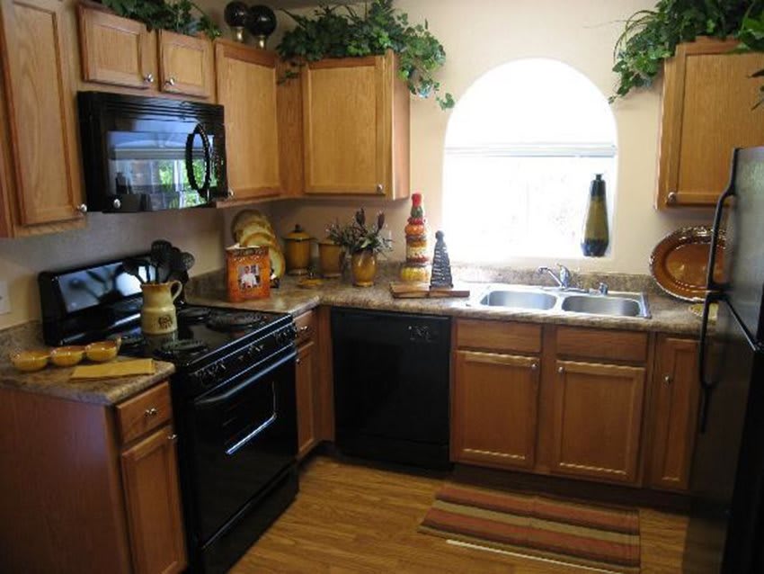 A cozy kitchen with wooden cabinets and modern appliances.