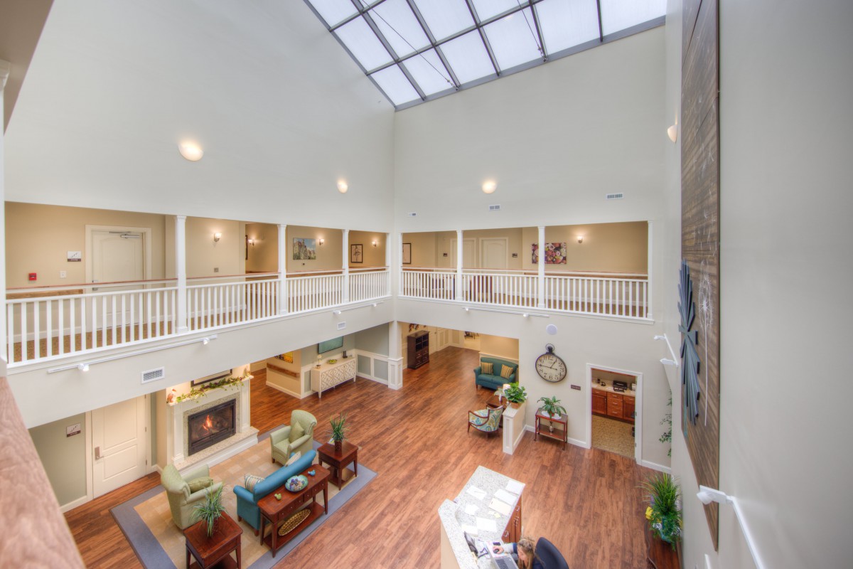 Spacious atrium lobby with skylight and comfortable seating.