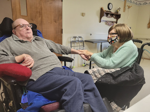 A heartwarming moment between a caregiver and an elderly individual, showcasing care and connection.