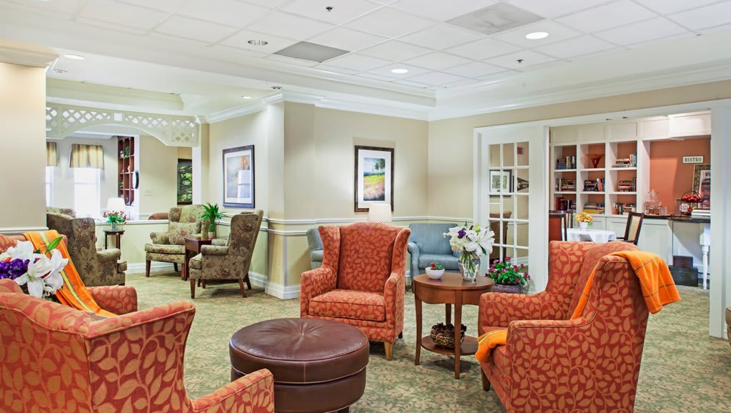 A cozy seating area with comfortable chairs and a small table, designed for relaxation in a lobby or waiting room.