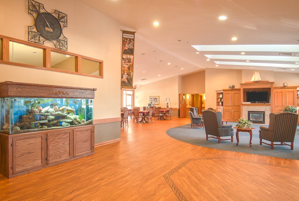 A modern lobby area featuring an aquarium, comfortable seating, and bright lighting.