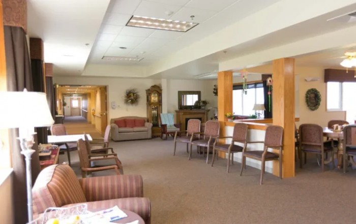 A cozy waiting room with multiple chairs and a reception area.