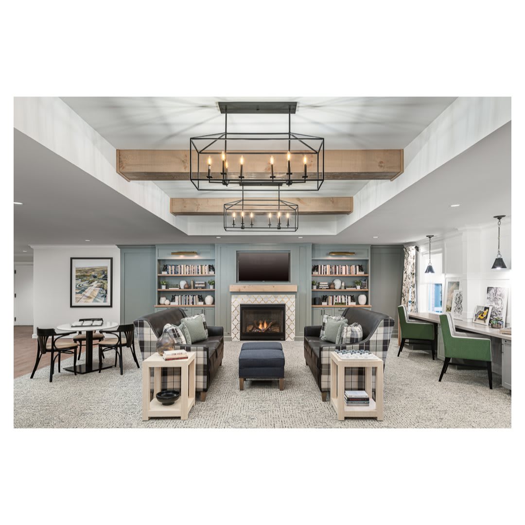 A modern living room with a central fireplace, stylish furniture, and elegant lighting.