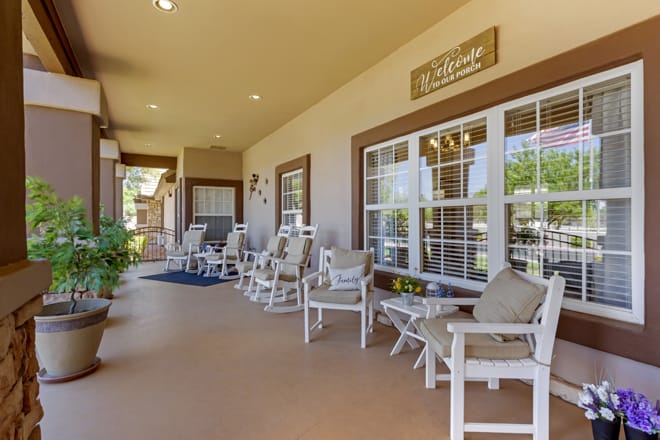An inviting porch with multiple rocking chairs and outdoor seating.