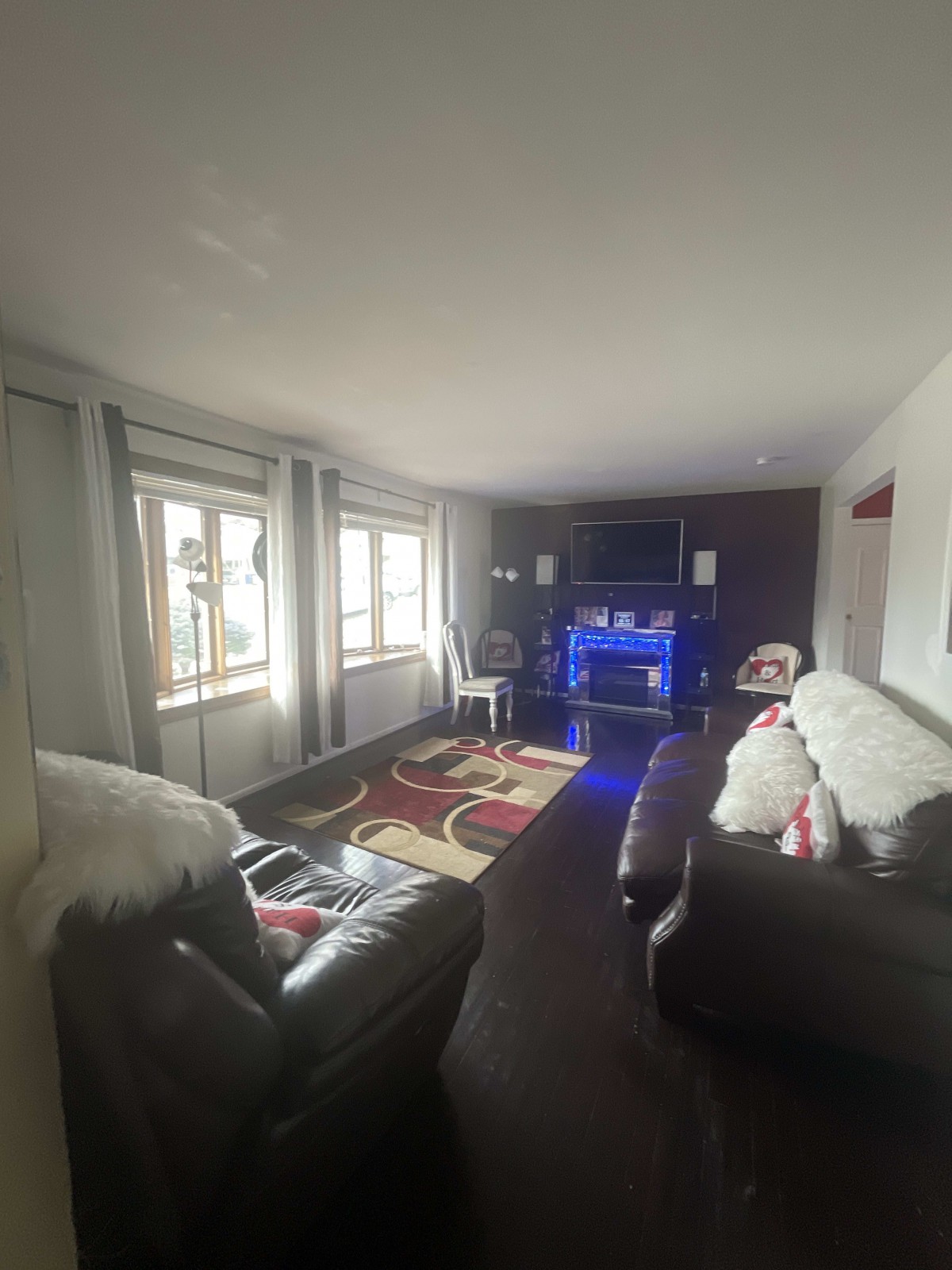 A cozy living room with modern furnishings and ambient lighting.