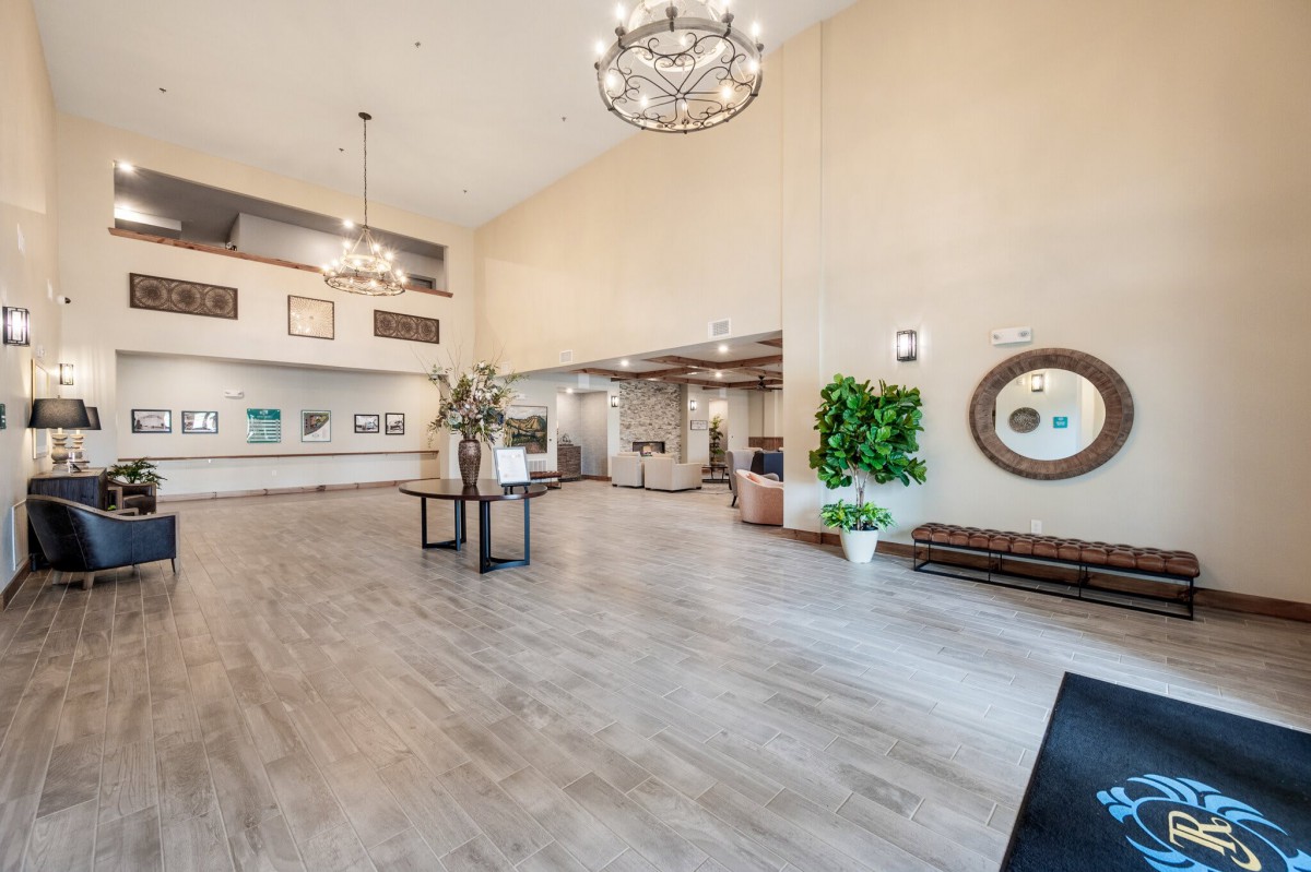 A spacious, modern lobby with chandeliers and decorative elements.