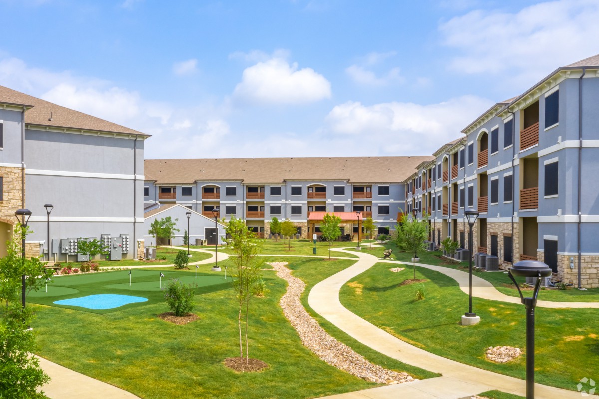 A well-maintained residential complex with pathways and landscaped gardens.