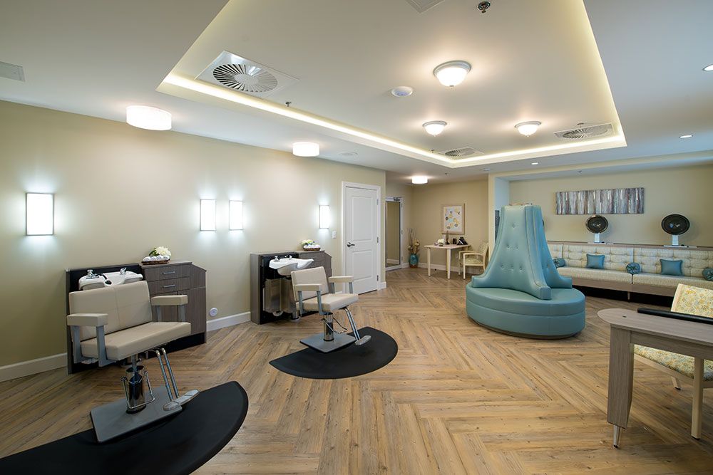 A modern salon interior with stylish seating and well-lit mirrors.
