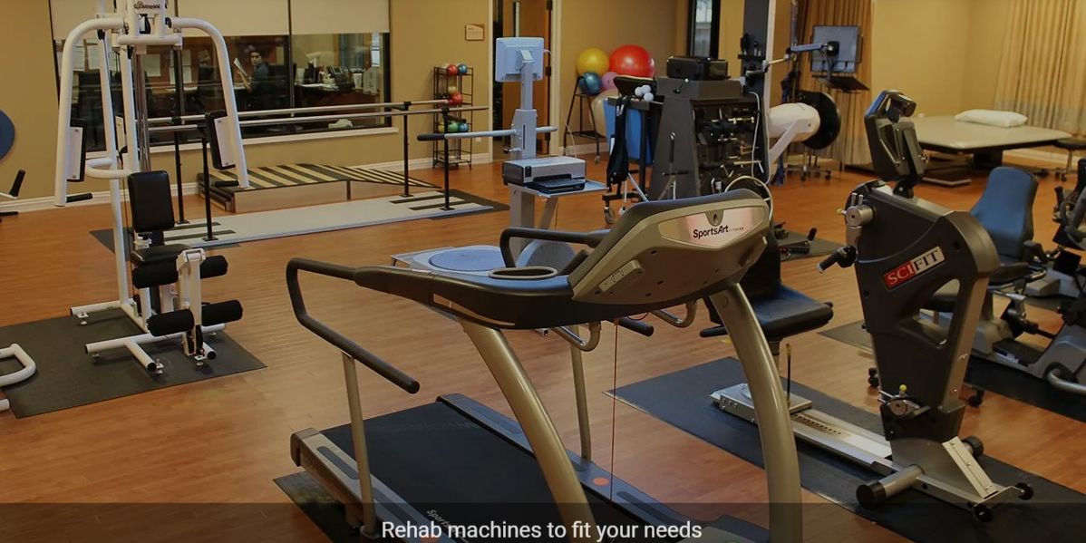 A rehabilitation gym with various exercise machines.