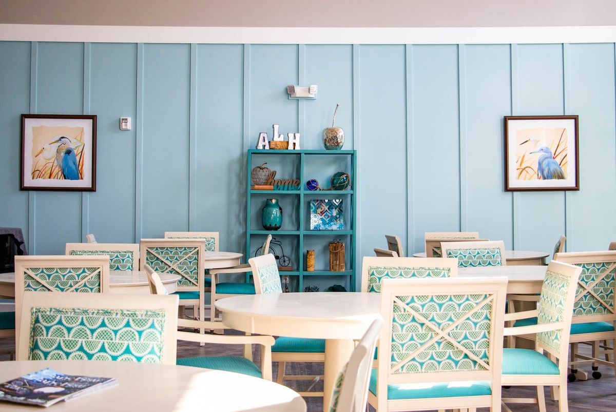 A bright and airy dining area with blue-themed decor and furnishings.