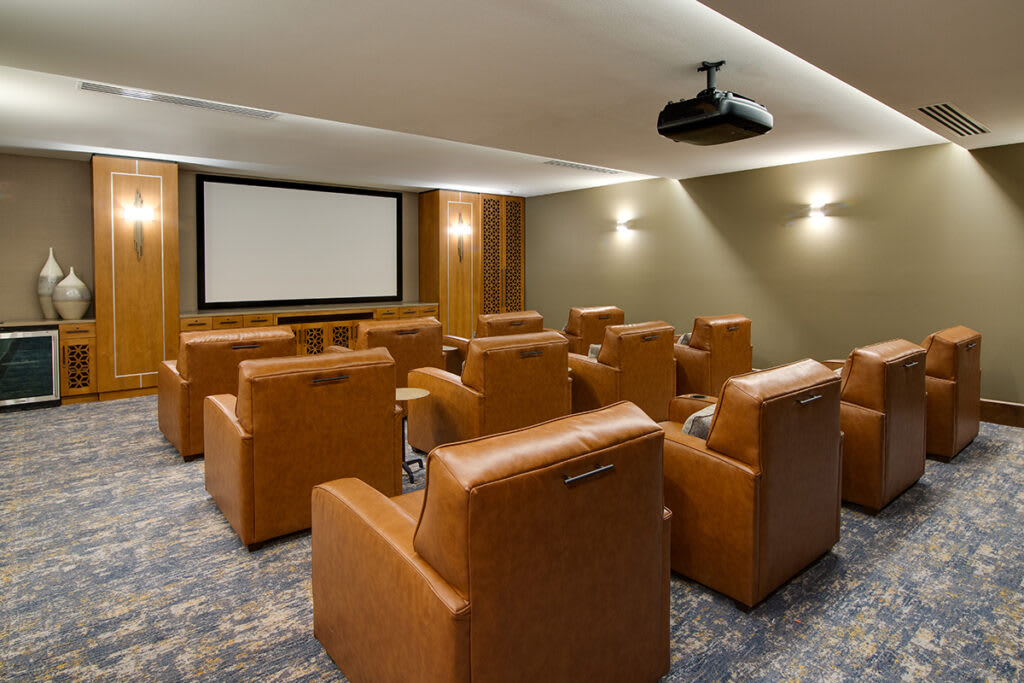 A luxurious home theater room with comfortable seating and a large projection screen.