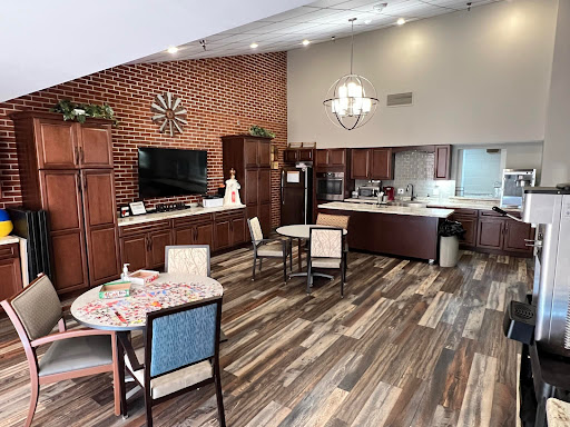 A contemporary kitchen and dining space featuring a blend of wood cabinetry and stylish furnishings.