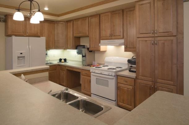 A modern kitchen with wooden cabinets and appliances.