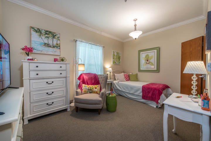 A cozy bedroom with colorful decor and comfortable furnishings.