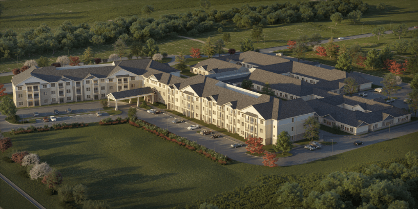 Aerial view of a large residential building surrounded by greenery and a parking lot.