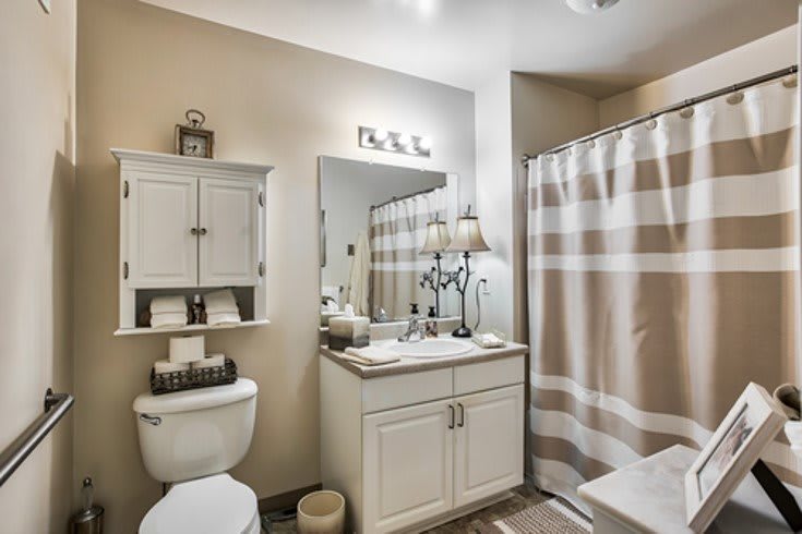 A modern bathroom with neutral tones and elegant decor.