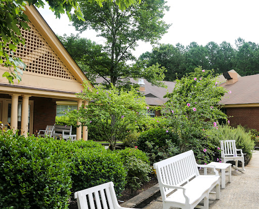 A serene outdoor space featuring well-maintained gardens and comfortable seating.