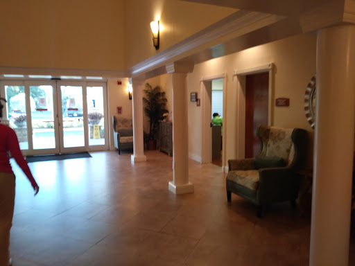 A spacious lobby area featuring elegant lighting and comfortable seating.